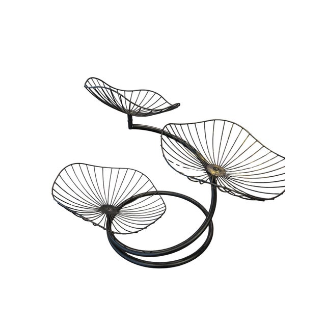 A wonderfully sculptural vintage Mid-Century Modern three-tier centerpiece constructed of black-finished metal with three...