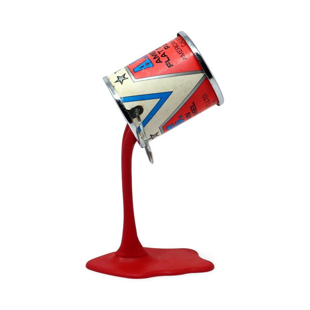 A perfectly Pop Art 1980s pouring paint can piggy bank/sculpture. Metal paint can with a quarter-sized coin slot in its...