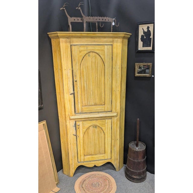 19thc Original painted mustard one Piece corner cupboard, Cover green painted interior. Probably Later paint on the...