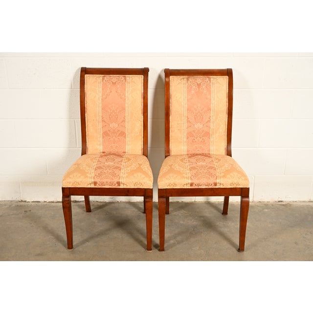 A gorgeous pair of Regency or Neoclassical style side chairs or dining chairs In the manner of Baker Furniture USA, Circa...