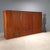 Large vintage wall cabinet with exotic wood veneer, brass handles and interior details. This piece is attributed to the...