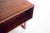 Rosewood desk, designed by Henning Jensen. Has a large rectangular top with six drawers at the front and an open shelf at...