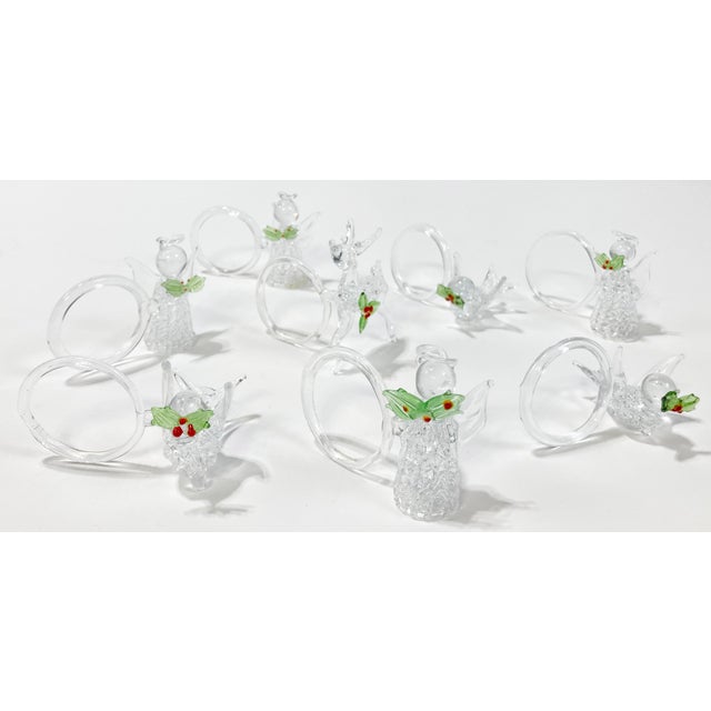 Set of 8 crystal holiday napkin rings depicting angels, birds, and deer each carrying a holly branch. Handcrafted without...