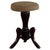 A finely crafted adjustable piano stool, featuring a round, upholstered seat and three elegantly curved cabriole legs...