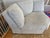 Light gray corner sectional piece is upholstered in a textured fabric with a subtle herringbone pattern. This wedge-shaped...