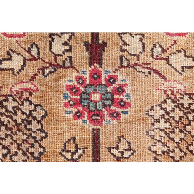 This antique Persian Tabriz rug, dating back to the early 20th century, is a distinguished offering from Doris Leslie...