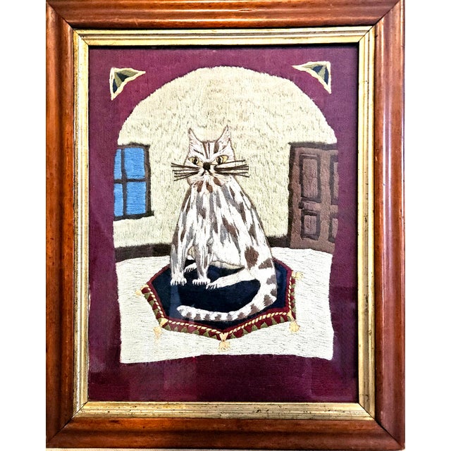 Folk Art Woolwork Depicting a Cat “The Tabby on the Rug” Circa 1860s This mid-19th-century sailor’s woolwork, possibly...