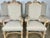 Set of Ten Italian Rococo style dining chairs with hand carved floral urn at tops of chairs. The urns are flanked by two...