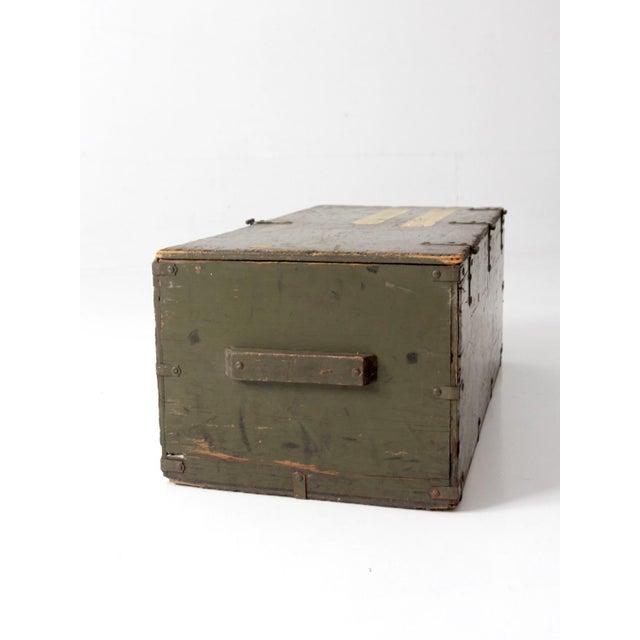 This 1943 World War II military storage crate carries decades of service history in its olive drab finish, stenciled...