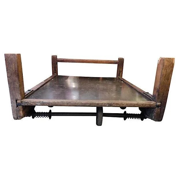 Wonderful use of old industrial cart with this large coffee table. One end has a cross bar while the other does not. It...