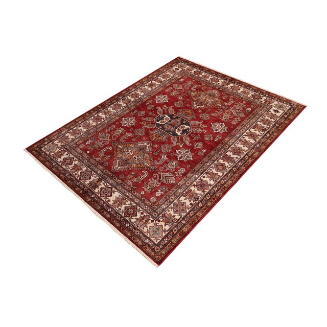 Enhance your home with this exquisite hand-knotted Super Kazak rug, crafted from fine hand-spun wool and dyed with all-...