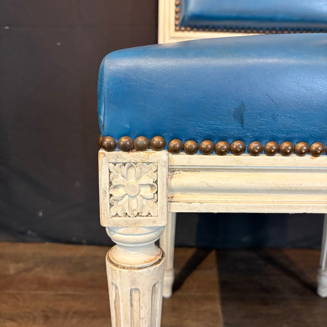 Elegant set of eight French Louis XVI dining chairs with beautifully painted frames, fluted tapered legs and finely carved...