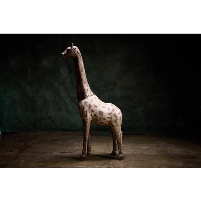 Large 19th century French giraffe sculpture made of wood with a distressed painted surface. - Constructed entirely of wood...