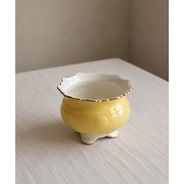 A cheerful and elegant little piece from one of England’s finest china houses, this Aynsley bone china cachepot is...