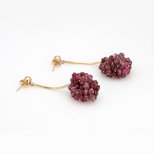Stylish pink tourmaline cluster earrings crafted in 14k yellow gold (circa 1980s). Pink tourmalines measure approx. 3.5mm...