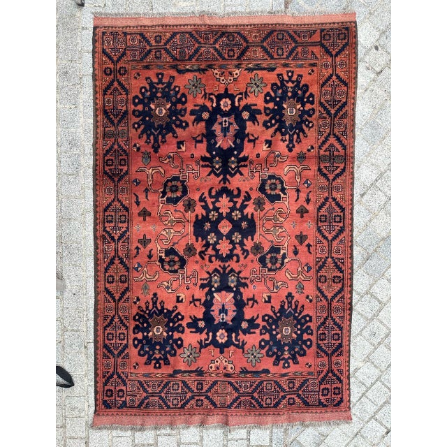 Beautiful Afghan rug from the late 20th century, entirely hand-knotted in wool on a wool foundation. It features stylized...
