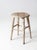 This is a vintage wooden farmhouse stool. The rustic wood stool features a round seat and tapered legs. Remnants of white...
