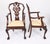 A beautiful antique set of twelve solid mahogany Chippendale Revival dining chairs, comprising ten sidechairs and two...