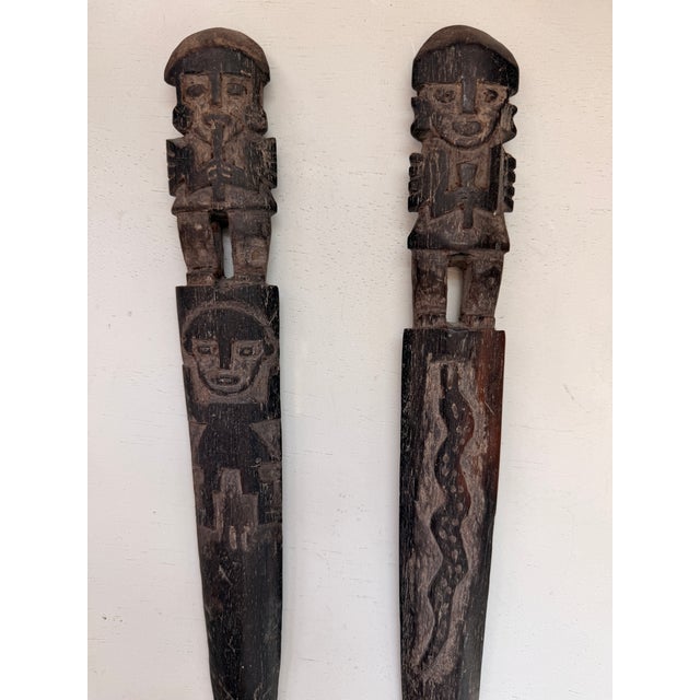These hand-carved objects are Chancay weaving tools, specifically referred to as weaving swords, battens, or beater...