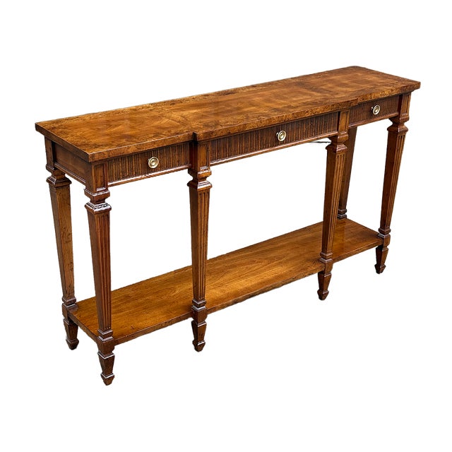 This is a beautiful 20th Century Drexel Heritage Neoclassical Silm console table. The top surface features a burlwood...