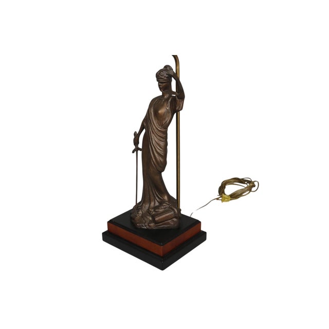 A bronzed metal sculpture table lamp of Lady Justice, made by SF Bay Trading Co. An iconic symbol for fairness and law,...