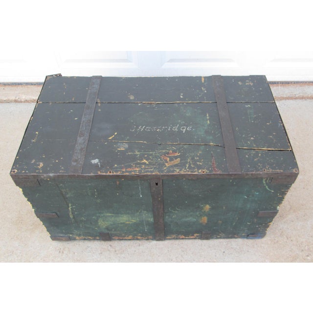 Antique green Seaman’s chest with metal straps. The top of the chest has the name “S. Hartridge” hand painted on it. The...