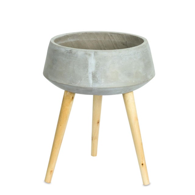 Elevate your greenery with this stylish Cement Bowl Planter on Wooden Legs. Featuring a sleek grey cement bowl atop warm,...