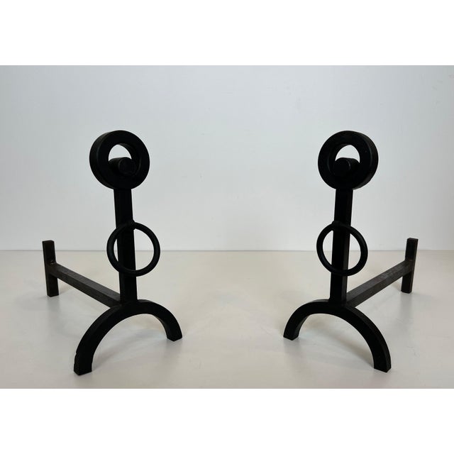 This beautiful pair of modernist andirons is made of wrought iron. It is a French work. Circa 1970.