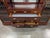 Solid mahogany entertainment wall unit with two tall diamond-leaded display cabinets flanking a mirrored center bay over...