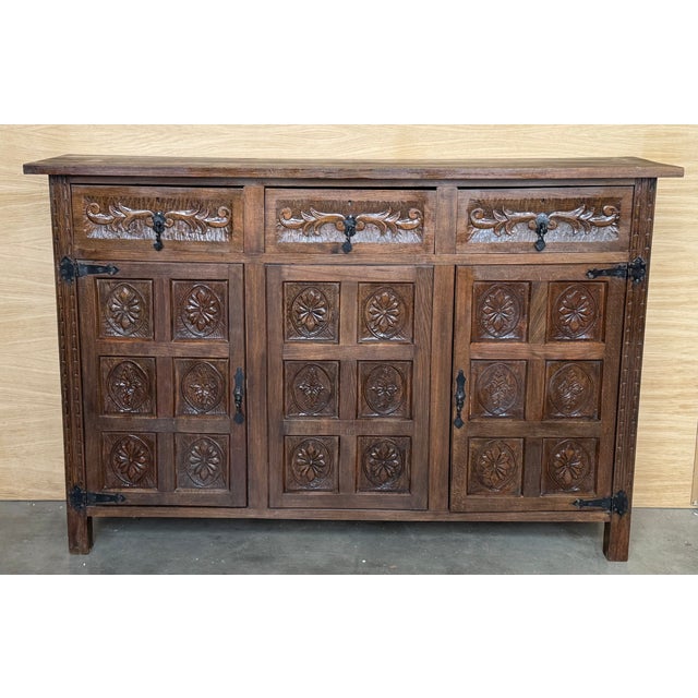 From Northern Spain, constructed of solid walnut, the rectangular top with molded edge atop a conforming case housing...