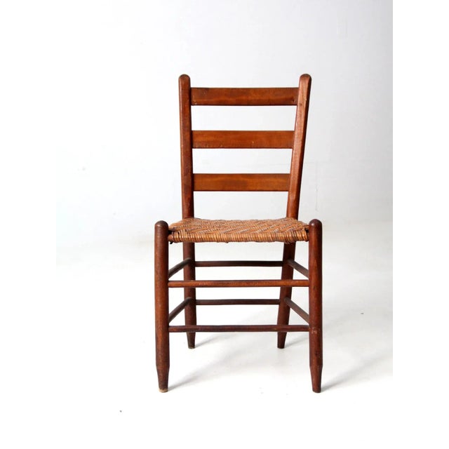 This is a beautiful antique splint weave seat chair. The rustic, natural wood chair features a ladder back and splint...