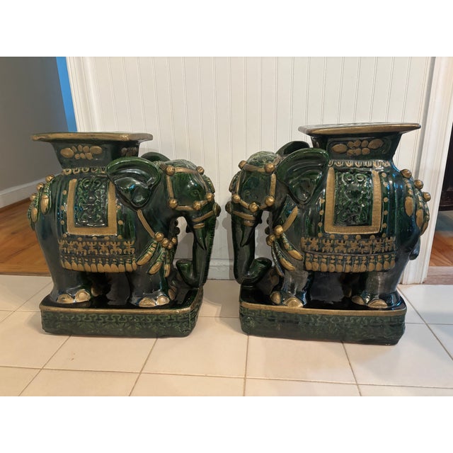 A pair of Emerald Green glazed terra cotta Elephant Garden Seats with gold accents and raised Chinese letters standing on...