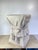 A striking trompe l'oeil plaster side table in the manner of John Dickinson, sculpted to resemble a square pedestal draped...