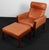 Hans j. Wegner lounge chair and ottoman, upholstered with patinated cognac leather. Frame of rossewood. Model ap 62, made...