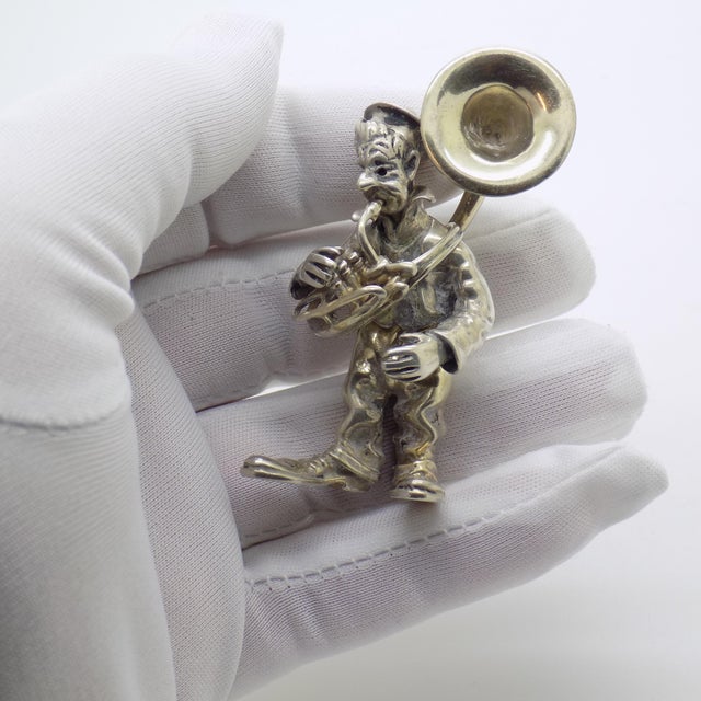 A playful yet highly collectible piece, this vintage Italian sculpture by Angini captures a whimsical street artist...