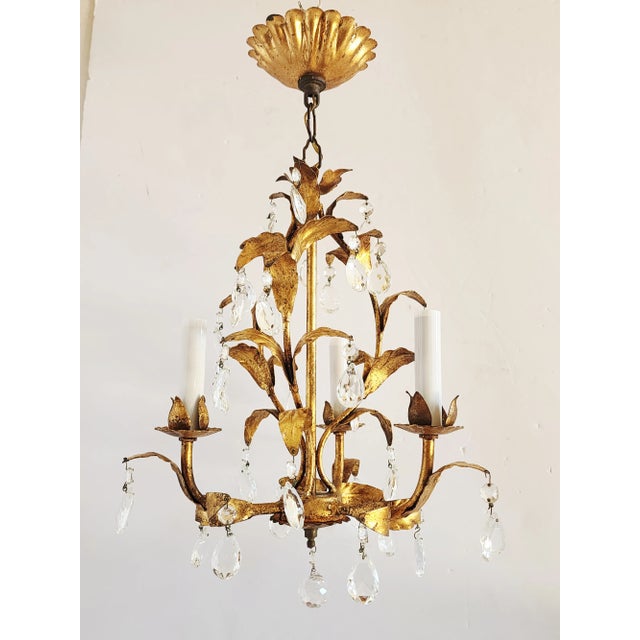 Vintage Mid-Century Hollywood Regency style, gilt tole petite chandelier with crystal prisms. A very charming little...