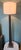 Black stitched leather floor lamp on a tiered brushed Nickel base. Base to top of finial is 62". The top of the lamp can...