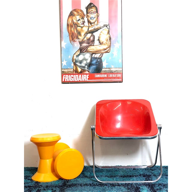 Plona red armchair designed in 1970 by giancarlo piretti for anonima castelli plona is a foldable and stackable armchair,...