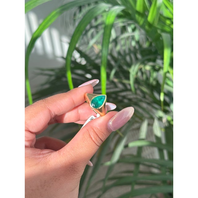 This striking signet unisex ring showcased one pear-cut emerald with total weight 2.67 carats, perfectly set in 18k yellow...