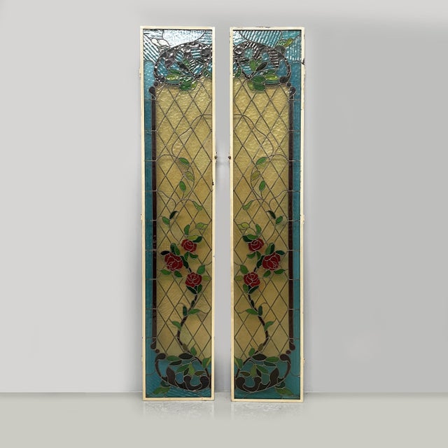 Tall stained-glass windows with roses, 1910s Pair of rectangular stained-glass panels with light-colored frames, made of...