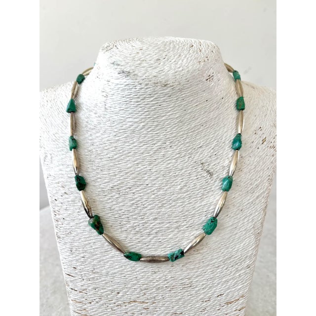 Handmade southwestern or Native American-style jewelry.It features irregularly shaped turquoise nuggets interspersed with...