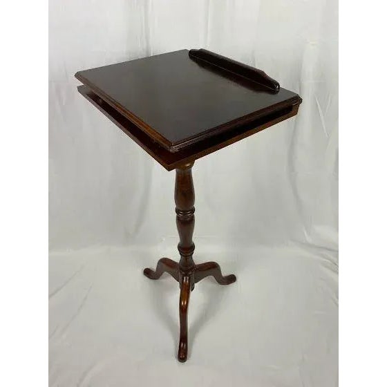 Classic foldable music / lectern stand resting on three legs. The top folds flat, opening to two pull up supports creating...