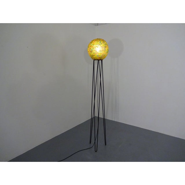 Large 1960s floor lamp with a looped stand made of black lacquered metal and a shade made of plastic/fiberglass. The...