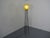 Large 1960s floor lamp with a looped stand made of black lacquered metal and a shade made of plastic/fiberglass. The...