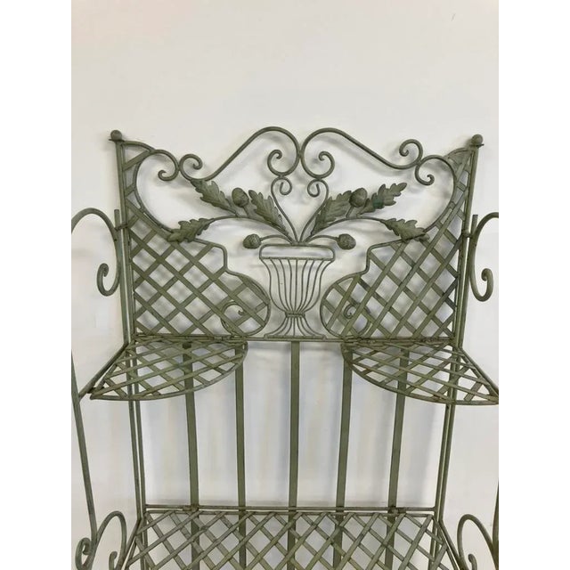 This vintage wrought iron shelf, dating from the late 20th century (circa 1970s–1980s), features three tiers of lattice...