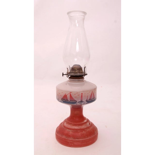 Circa 1930s glass kerosene lantern with sailboats and lighthouse motif. Lantern is in working order, will need kerosene to...