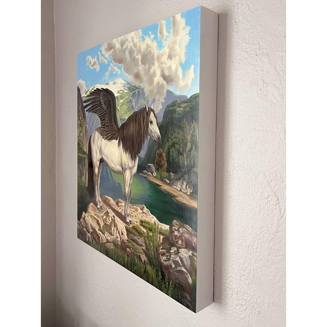 Figurative Pegasus by Robin Hextrum | Oil on wood panel of a winged horse by a lake in a mountainous landscape For Sale - Image 3 of 5