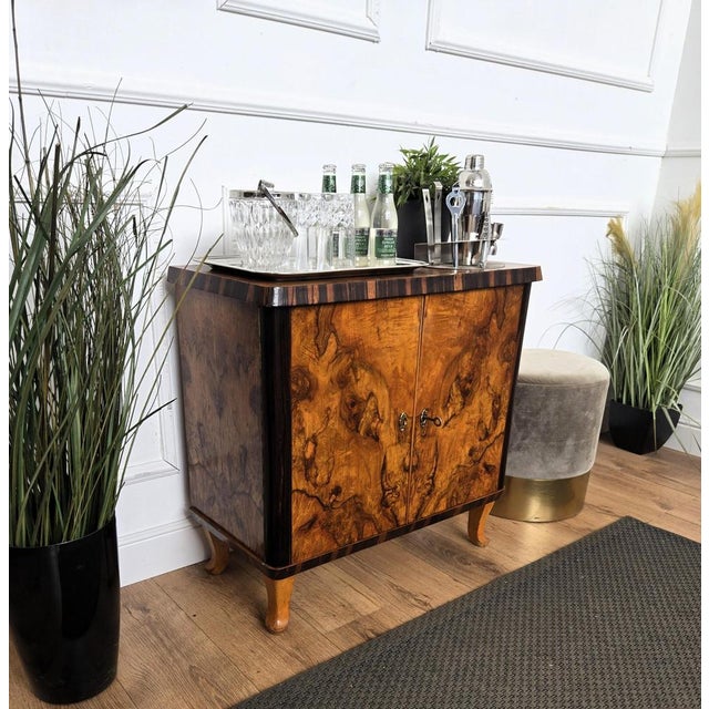Beautiful 1950s Italian Art Deco bar cabinet in great wood veneer front double doors standing on four classic legs giving...