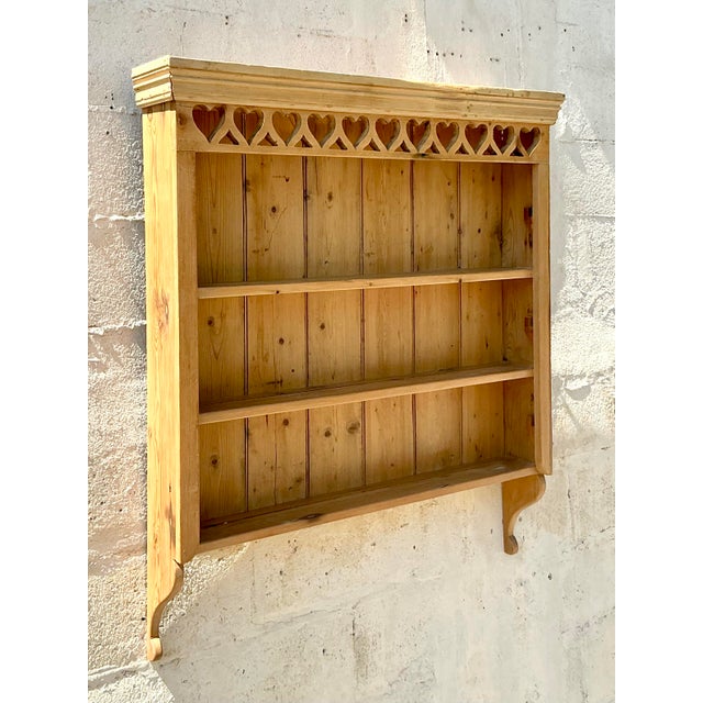 Add a touch of rustic romance to your space with this charming Vintage Boho Carved Heart Wall Shelf. Crafted from warm-...