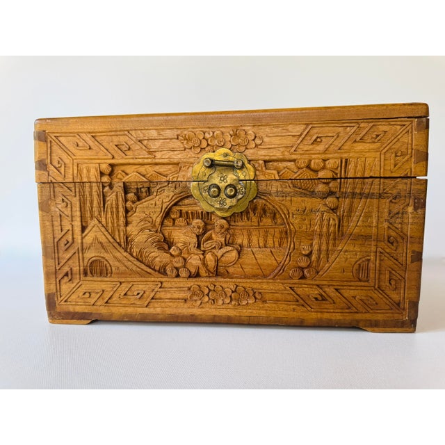 Vintage hand-carved Chinese hardwood keepsake box featuring deeply carved scenic panels on every side, traditional...